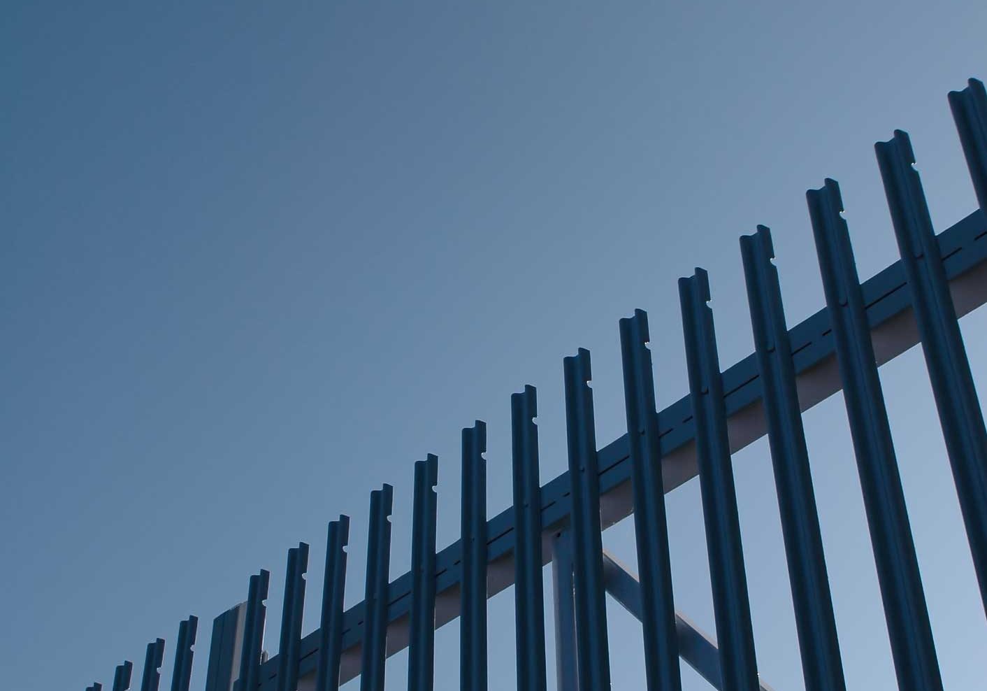 Security gates. Steel security gate abstract against blue sky