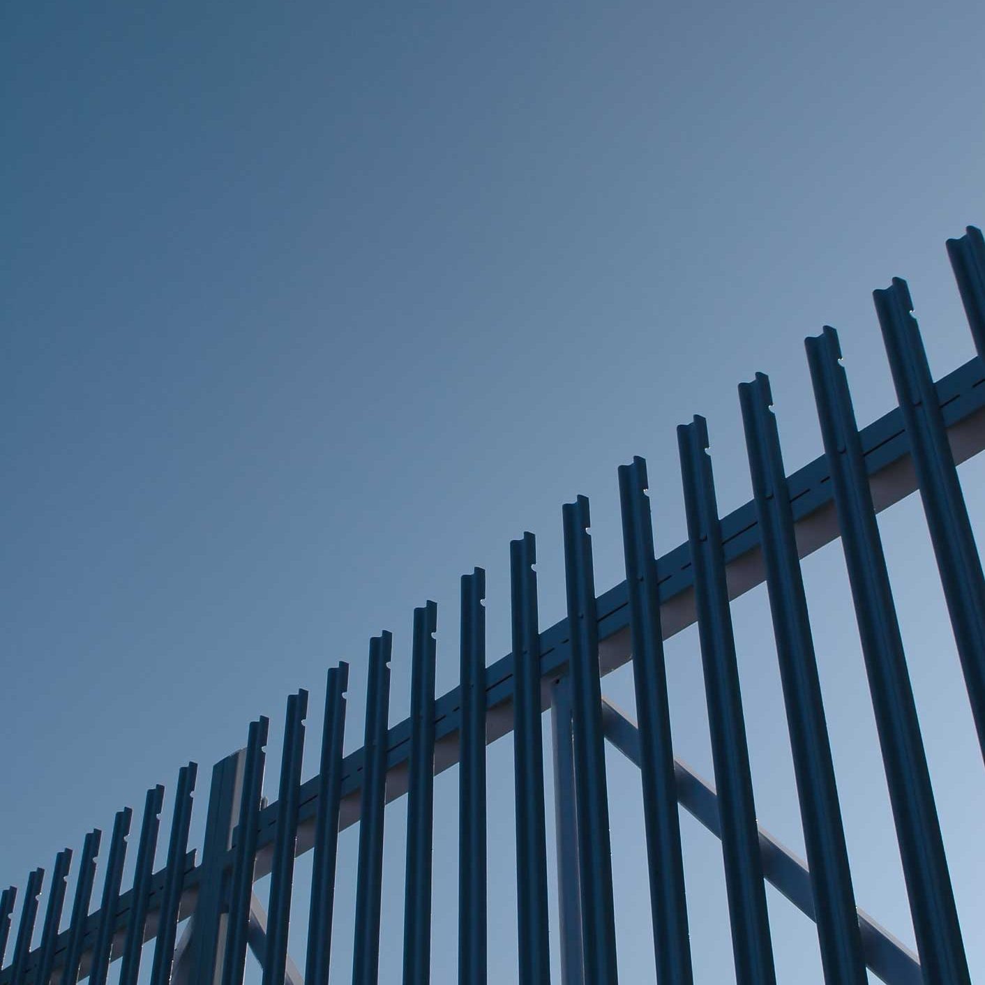 Security gates. Steel security gate abstract against blue sky